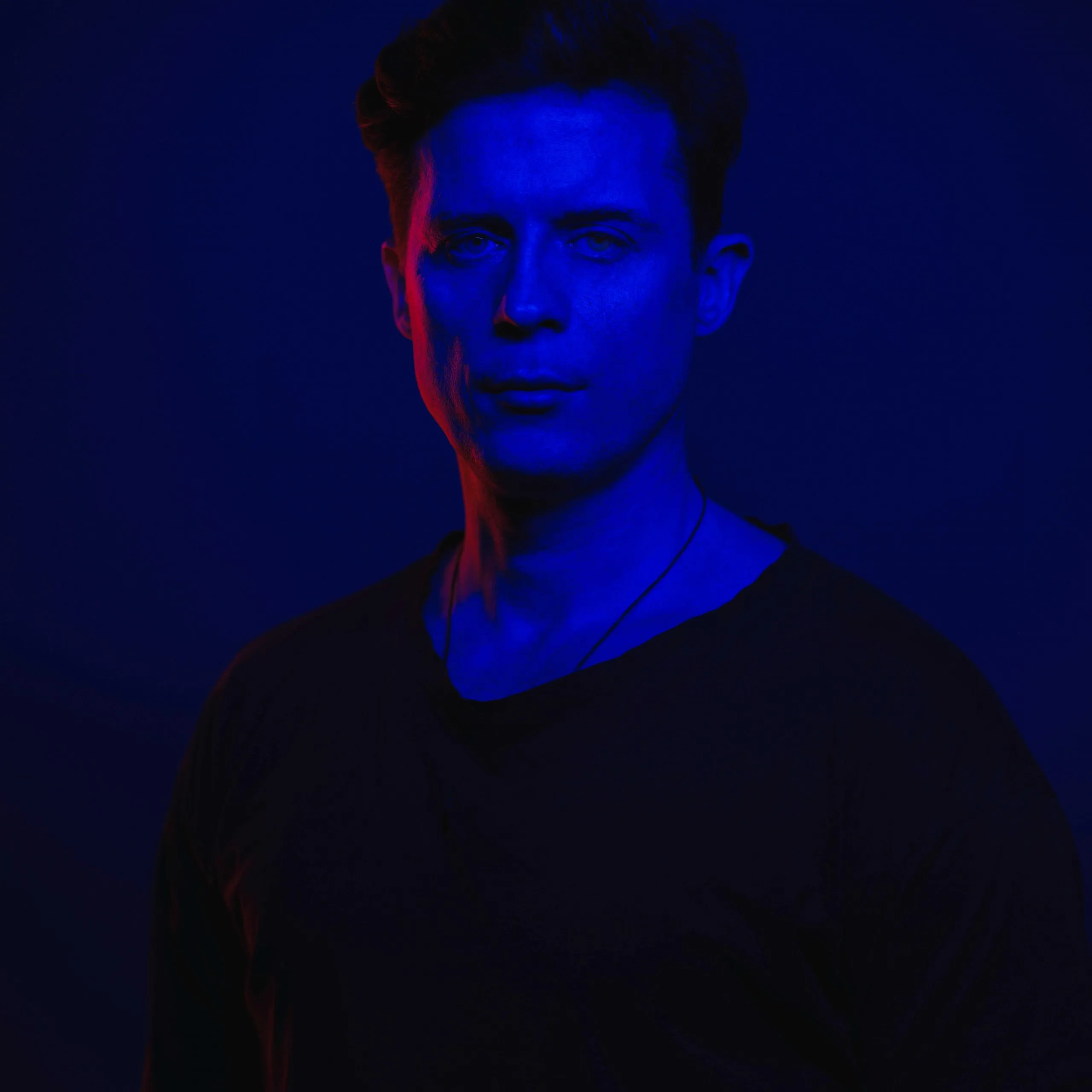 Luke Erb, portrait in deep blue light with a red rim