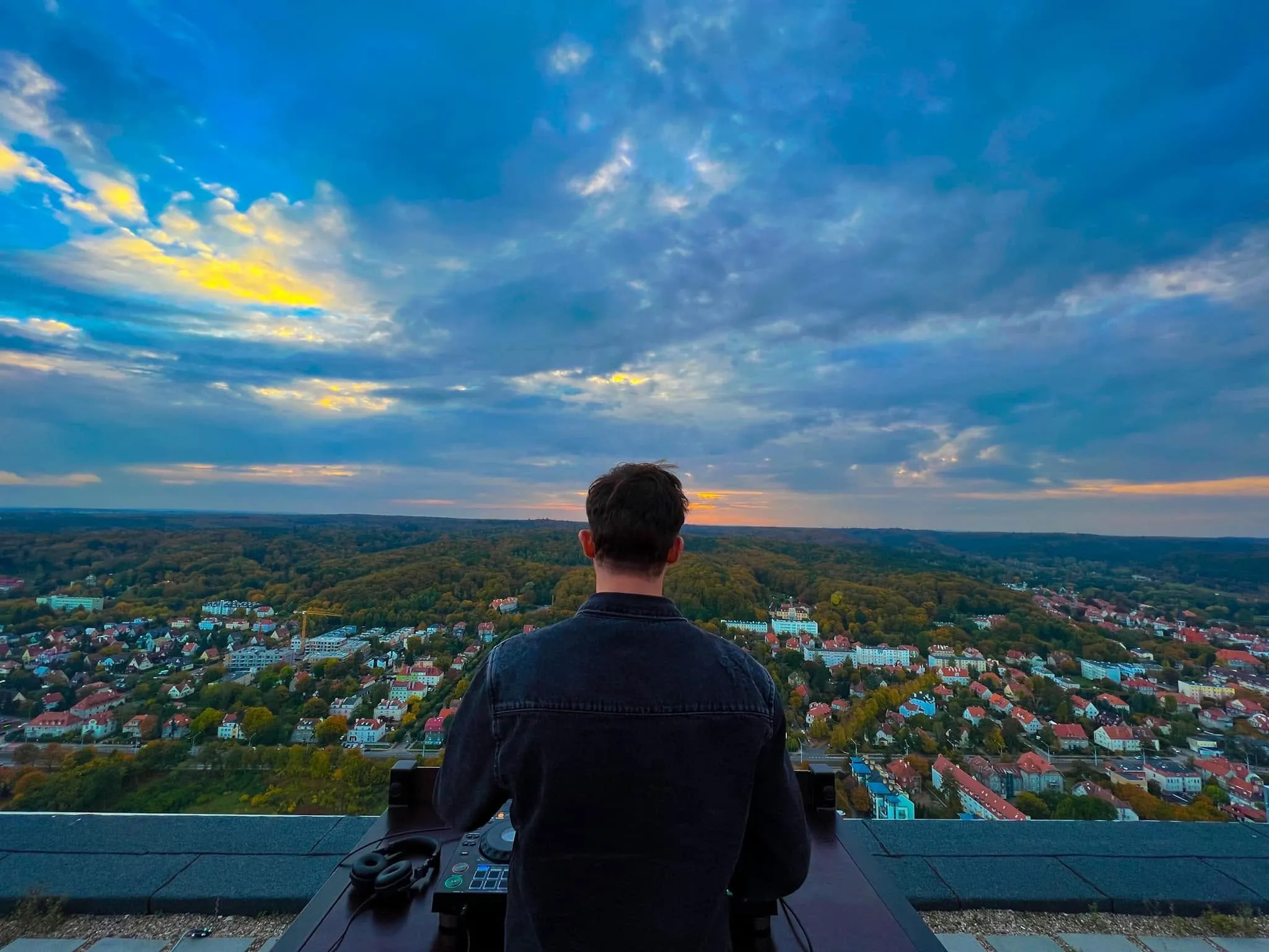 Luke Erb at the decks above Gdynia at dusk, clouds over green hills