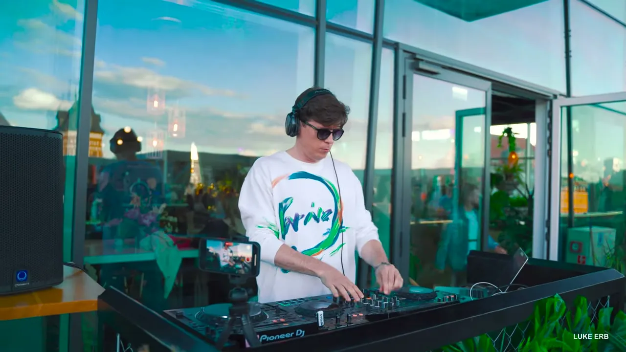 Luke Erb playing a rooftop live set above the Gdansk skyline at dusk
