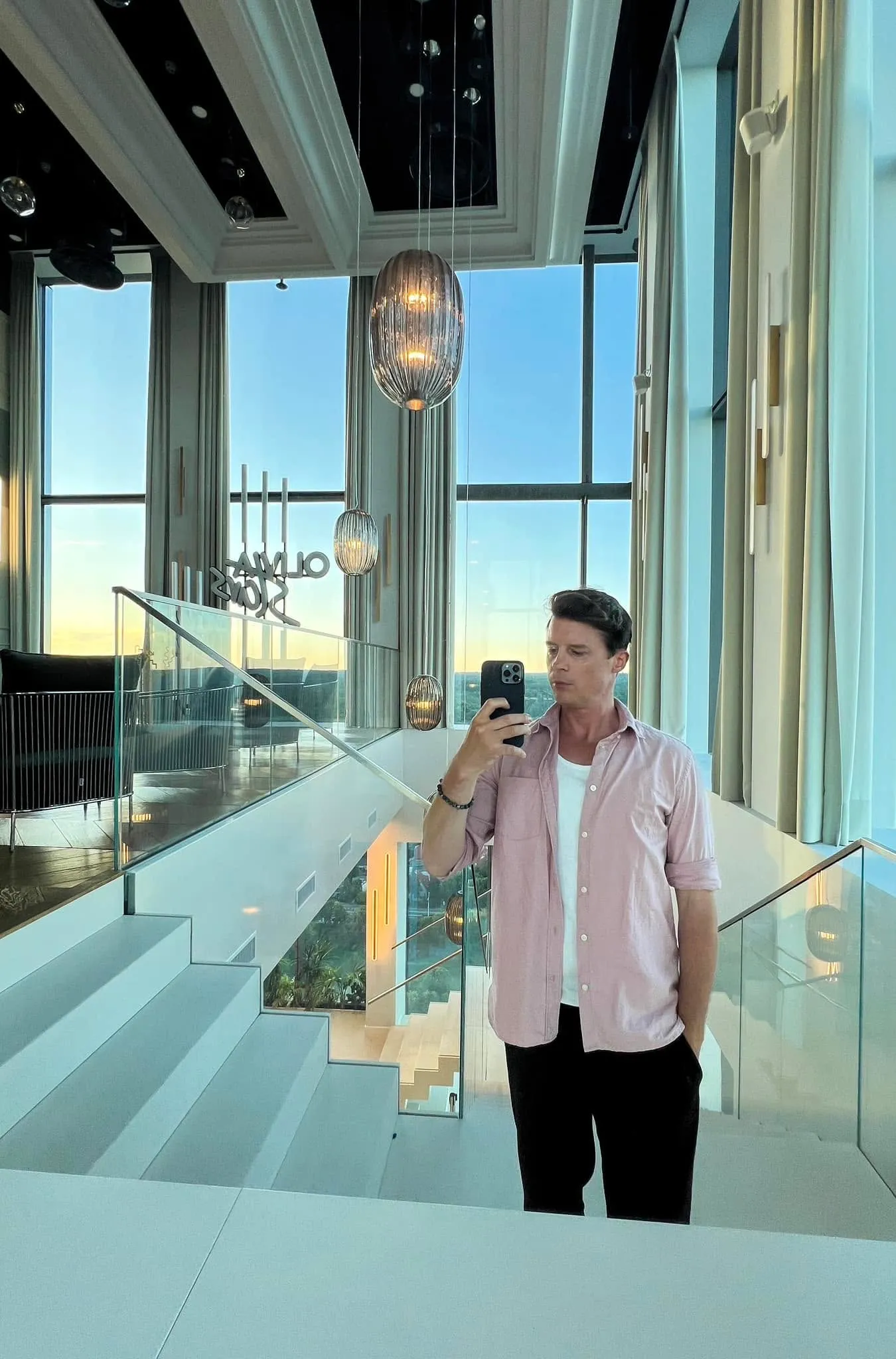 Luke Erb at Olivia Star, Gdansk, with the Baltic sunset behind floor-to-ceiling windows