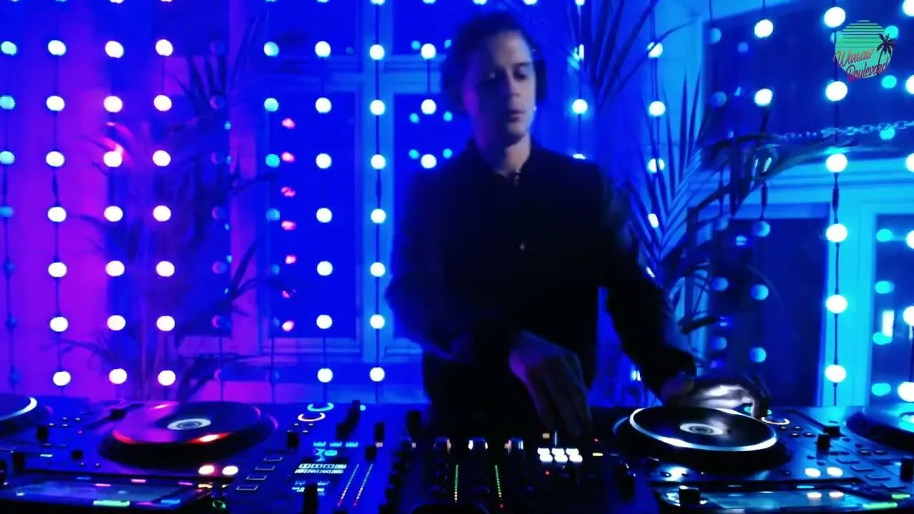 Luke Erb at Smolna, Warsaw, behind the decks in front of a curtain of LED lights