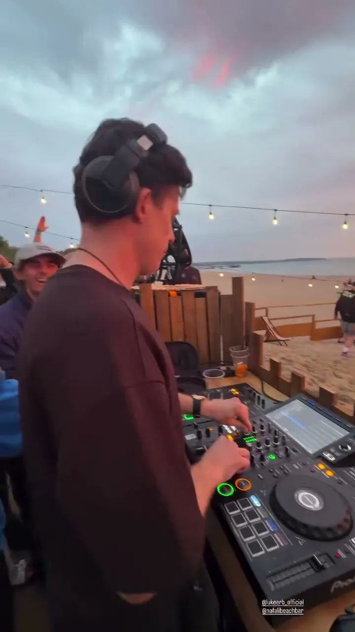 Luke Erb playing a sunrise set on the beach decks at Nafali Beach Bar